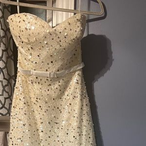 White sequins evening gown with belt.